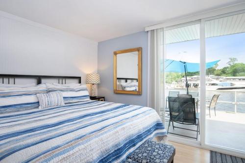 a bedroom with a bed and a window with a view at Waterside Suites in Saugatuck
