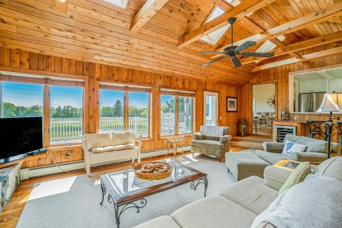 a living room with wooden walls and a ceiling at Birchwood: Meadows Bliss in Harbor Springs