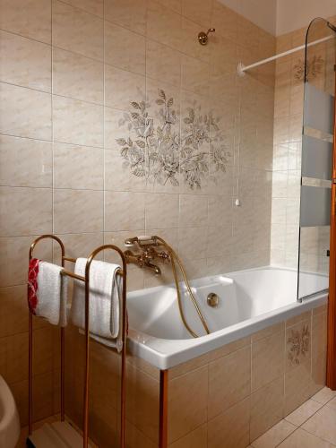 a bathroom with a bath tub and a sink at La Casa del Benessere in Campobasso