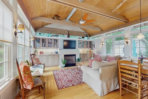 a living room with a white couch and a fireplace at Happy Thoughts Cottage in New Buffalo