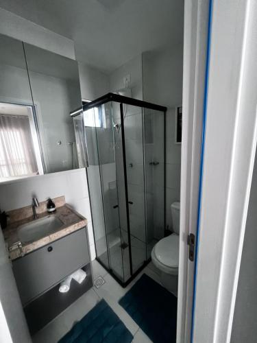 a bathroom with a shower and a toilet and a sink at Laguna beach house in Cabedelo