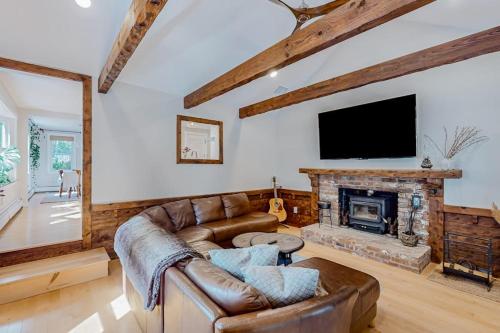 a living room with a couch and a fireplace at Private Pocasset Getaway in Pocasset