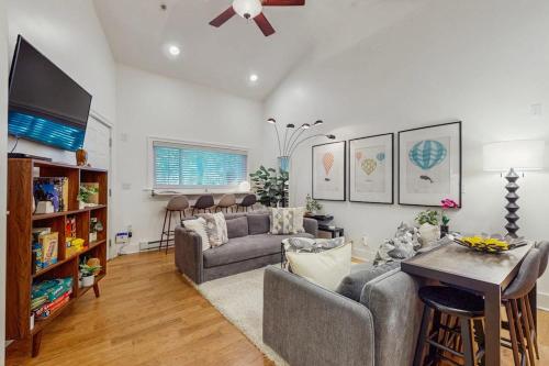 a living room with a couch and a tv at Arrowhead Resort - Undeniably Darling in Saugatuck