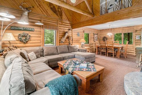 a living room with a couch and a table at The Log Cabin in Thompsonville