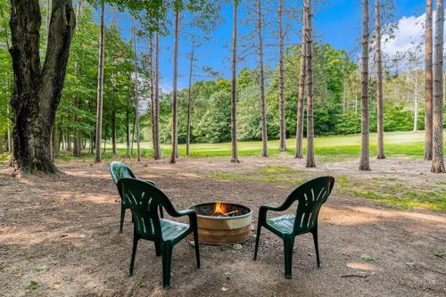 two chairs and a fire pit in a park at The Log Cabin in Thompsonville