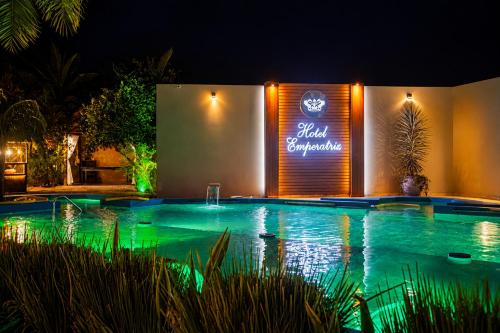 a swimming pool at night with a lit up sign at Hotel Termal Emperatriz Termas de Río Hondo in Termas de Río Hondo