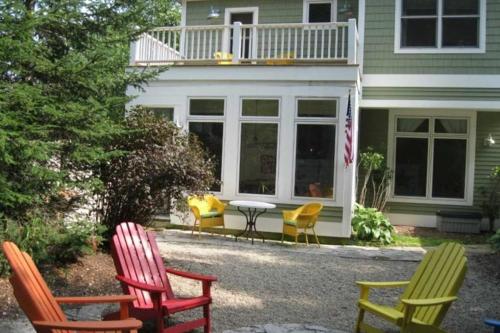 a group of chairs sitting outside of a house at Sunshine Villa in Union Pier