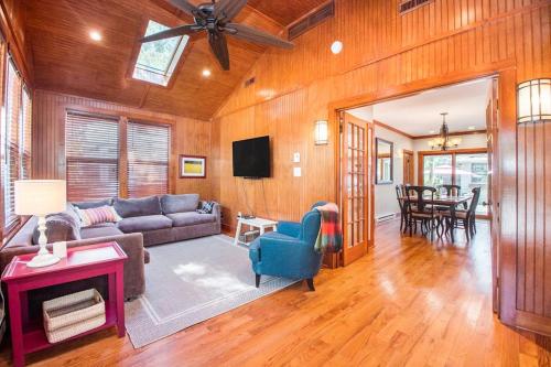 a living room with a couch and a tv at Coast Away in Union Pier