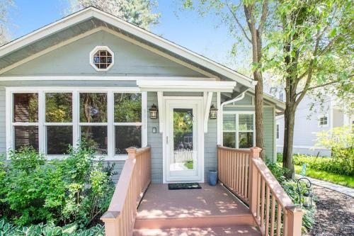 a home with a porch with a white door at Coast Away in Union Pier
