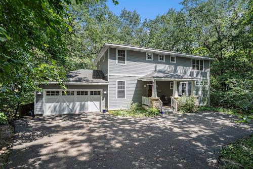 a white house with a garage and a driveway at The Oasis at Forest Beach in New Buffalo