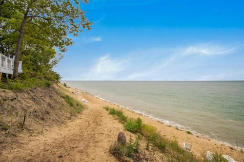 a sandy beach next to the ocean on a clear day at The Oasis at Forest Beach in New Buffalo