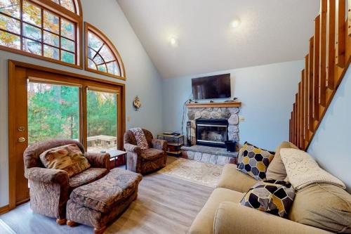 a living room with a couch and a fireplace at Creeping Snails in Glen Arbor