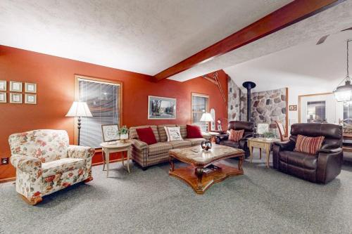 a living room with a couch and chairs and a table at Crystal Mountain Retreat in Thompsonville