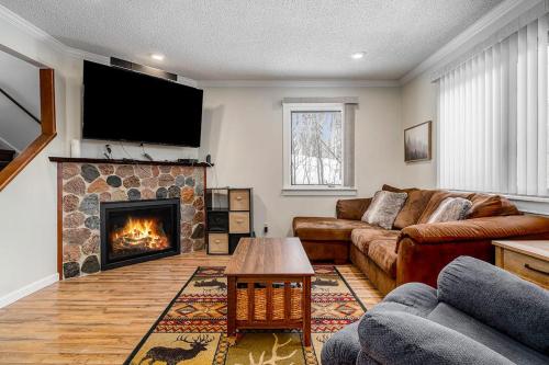 a living room with a couch and a fireplace at Hideaway Valley Condo 36 in Harbor Springs
