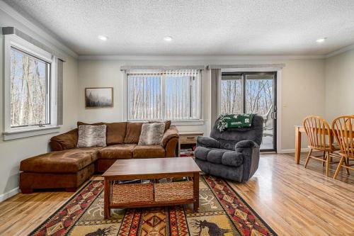 a living room with a couch and a table and chairs at Hideaway Valley Condo 36 in Harbor Springs