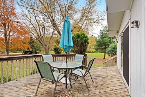 a table and chairs with an umbrella on a deck at Generations in Douglas
