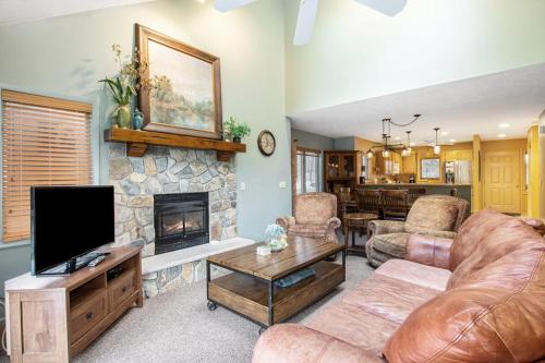 a living room with a couch and a fireplace at Mountainside 612 in Thompsonville
