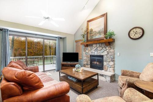 a living room with a couch and a fireplace at Mountainside 612 in Thompsonville