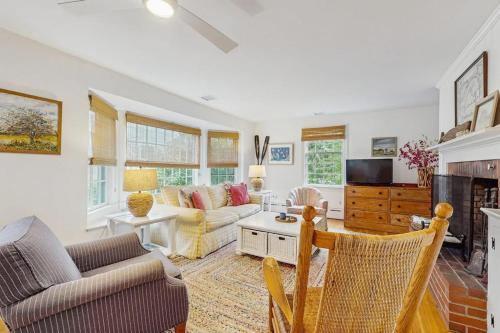 a living room with a couch and a fireplace at Cozy Corner in Edgartown