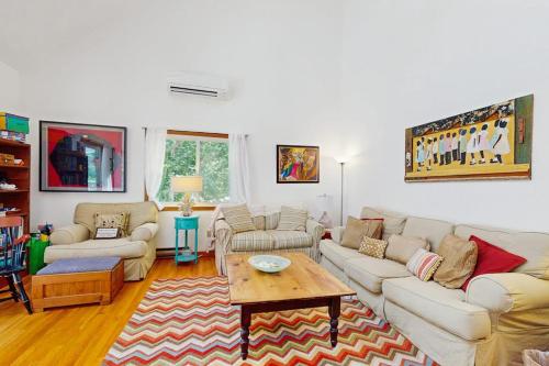 a living room with couches and a coffee table at The Big Easy in Oak Bluffs