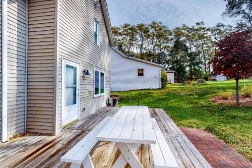 a wooden bench sitting on the side of a house at Beach House in Empire