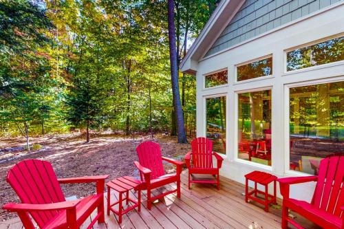 a group of red chairs sitting on a porch at Deer Park 9 in Glen Arbor