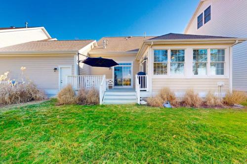 a white house with an umbrella on the front yard at Bear Trap Dunes---26 Willow Oak Ave in Ocean View