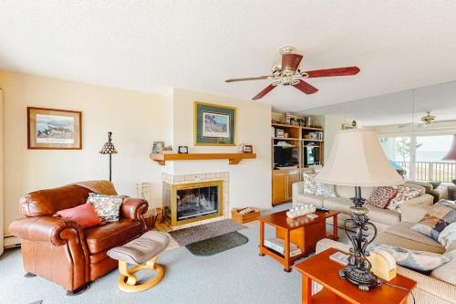 a living room with a couch and a fireplace at South Beach 53 in Glen Arbor