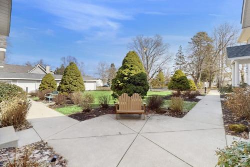 a bench sitting on a sidewalk in a yard at Beacon Court D in Douglas