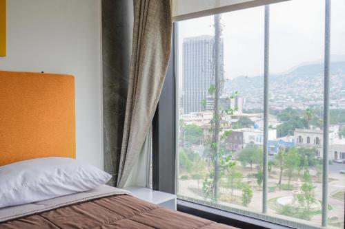 a bedroom with a bed and a large window at Purísima 5 0 in Monterrey
