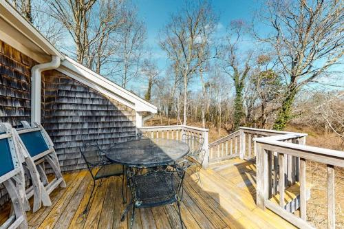 a wooden deck with a table and chairs on a house at Paradise On Cape Cod in Orleans