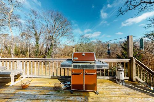 a grill on a deck with a laptop on it at Paradise On Cape Cod in Orleans