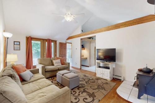 a living room with a couch and a tv at esCAPE in Eastham