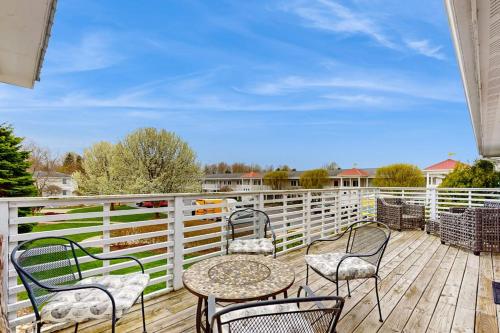 a patio with a table and chairs on a wooden deck at Northern Light Condominiums: Jack's Perch in Douglas