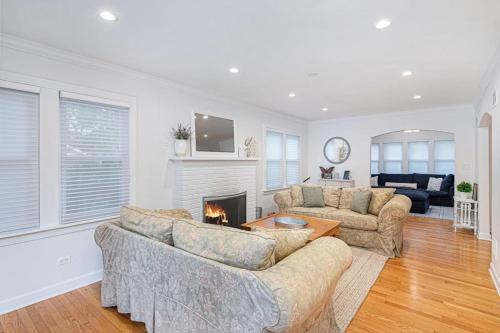 a living room with two couches and a fireplace at Butterfly Pool House in Lakeside