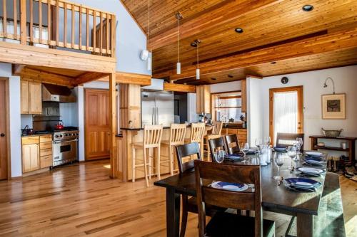 a dining room and kitchen with a table and chairs at Chalet Du Bois in Harbert