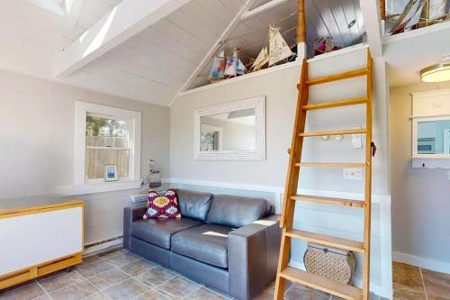 a living room with a couch and a ladder at Anchorage Escape in Truro