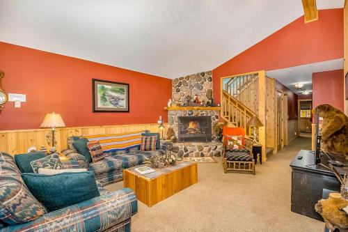 a living room with a couch and a fireplace at Whispering Pines in Thompsonville