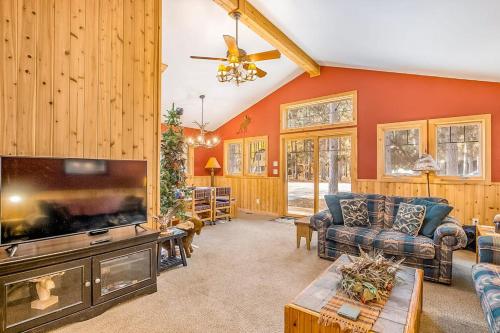 a living room with a large flat screen tv at Whispering Pines in Thompsonville