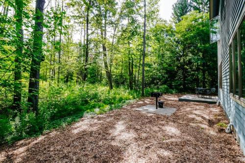 a backyard with a grill on the side of a house at Wintergreen Condo, Unit 540 in Thompsonville