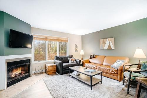 a living room with a couch and a fireplace at Wintergreen Condo, Unit 540 in Thompsonville