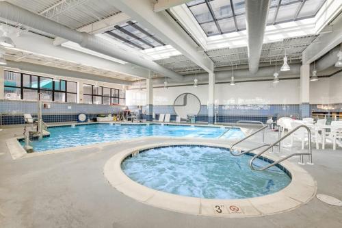 a large swimming pool with blue water in a building at Sea Colony - 56010 Pine Shore in Bethany Beach