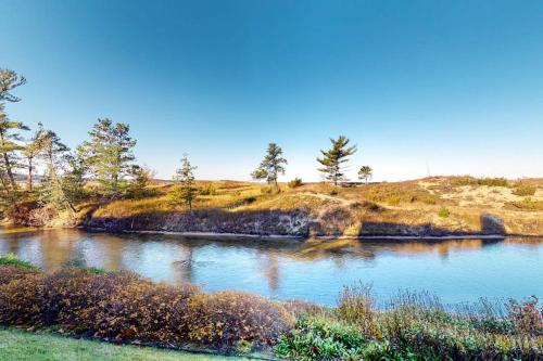 a body of water with trees on top of a hill at Gentle Winds 9 10 in Glen Arbor
