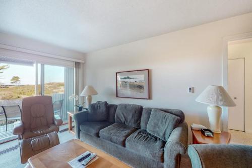 a living room with a couch and a chair at Gentle Winds 9 10 in Glen Arbor
