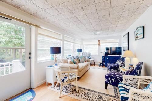 a living room with a couch and chairs at Paradise by Ocean Edge in Brewster