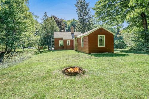 a small house with a fire in the yard at Hal's Hideaway in Beulah