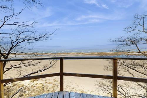 a view of the beach from the balcony of a house at Heron Creek in Laketown Township