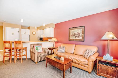 a living room with a couch and a table at Crystal Mountain Condo - Wintergreen 535 in Thompsonville