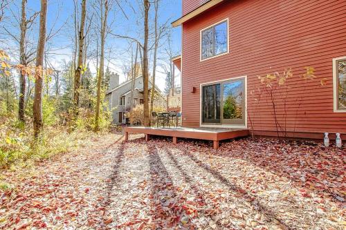a red house with a bench in front of it at Crystal Mountain Condo - Wintergreen 535 in Thompsonville