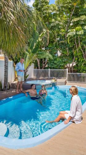a group of people sitting in a swimming pool at Coastal Beach Retreat in Clearwater Beach